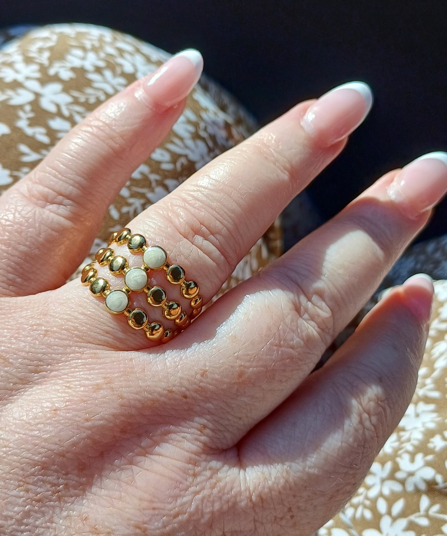 Evelyn is a three tiered 18K AAA gold plated ring with gold and white bead design