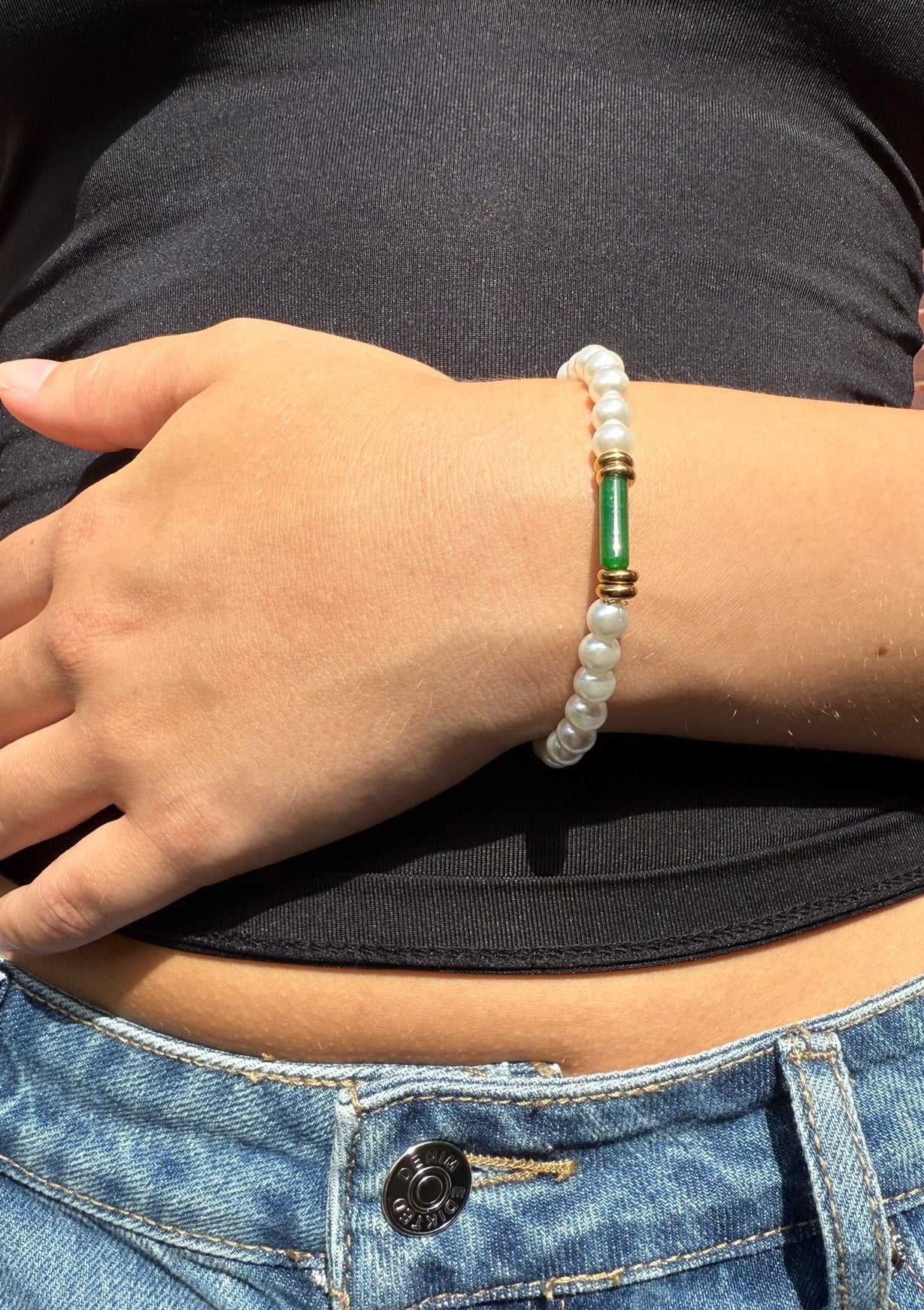 Anastacia is a pearl beaded bracelet with an 18k AAA gold plated beads and a green crystal