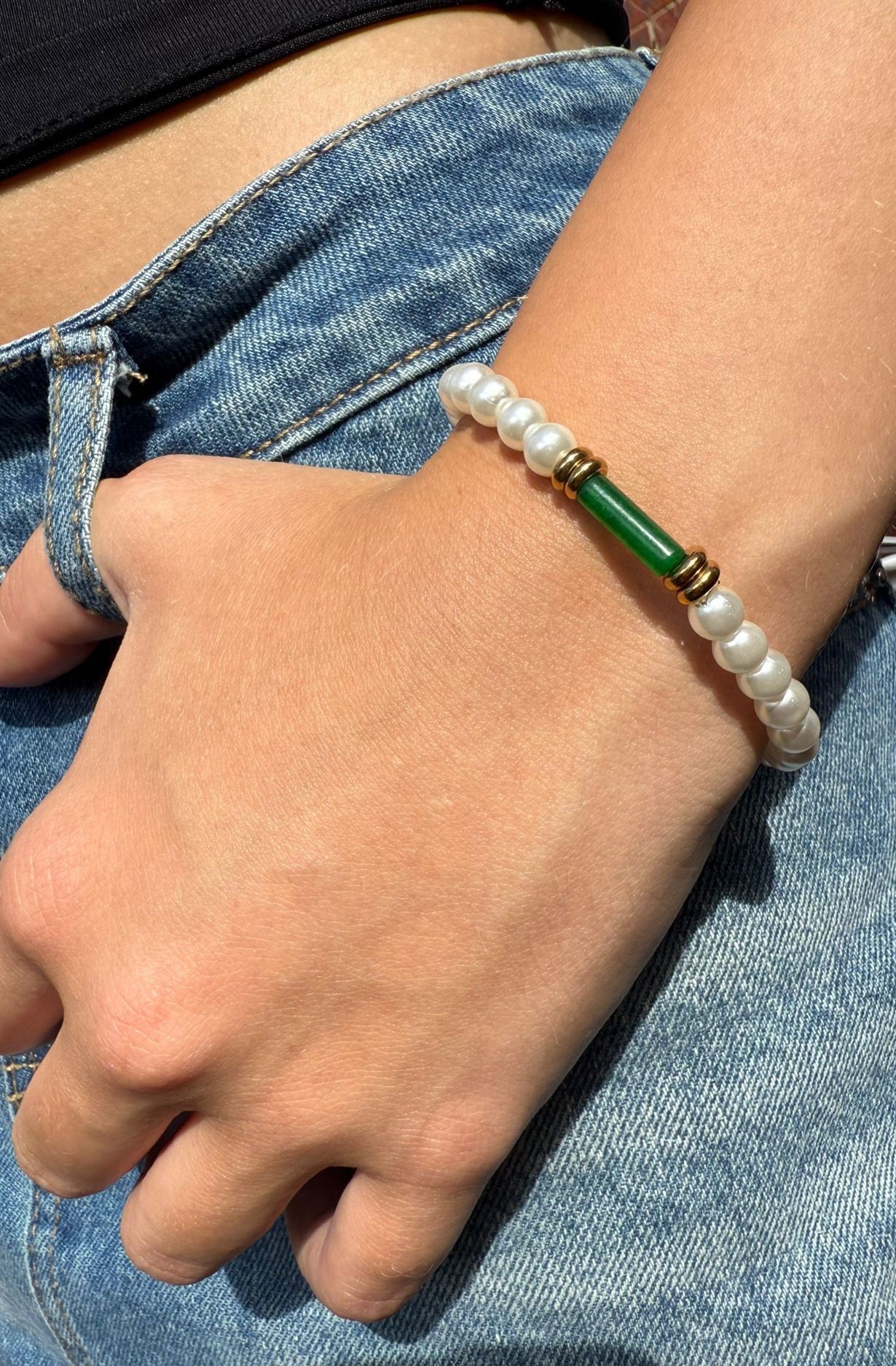 Anastacia is a pearl beaded bracelet with an 18k AAA gold plated beads and a green crystal