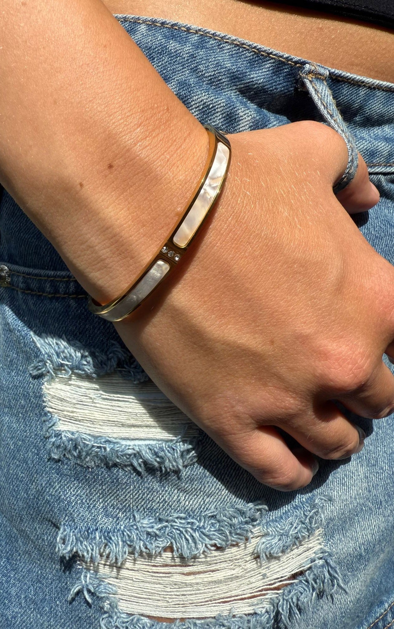 Margo is a 18k AAA gold plated bangle with a white band and small zircon gems