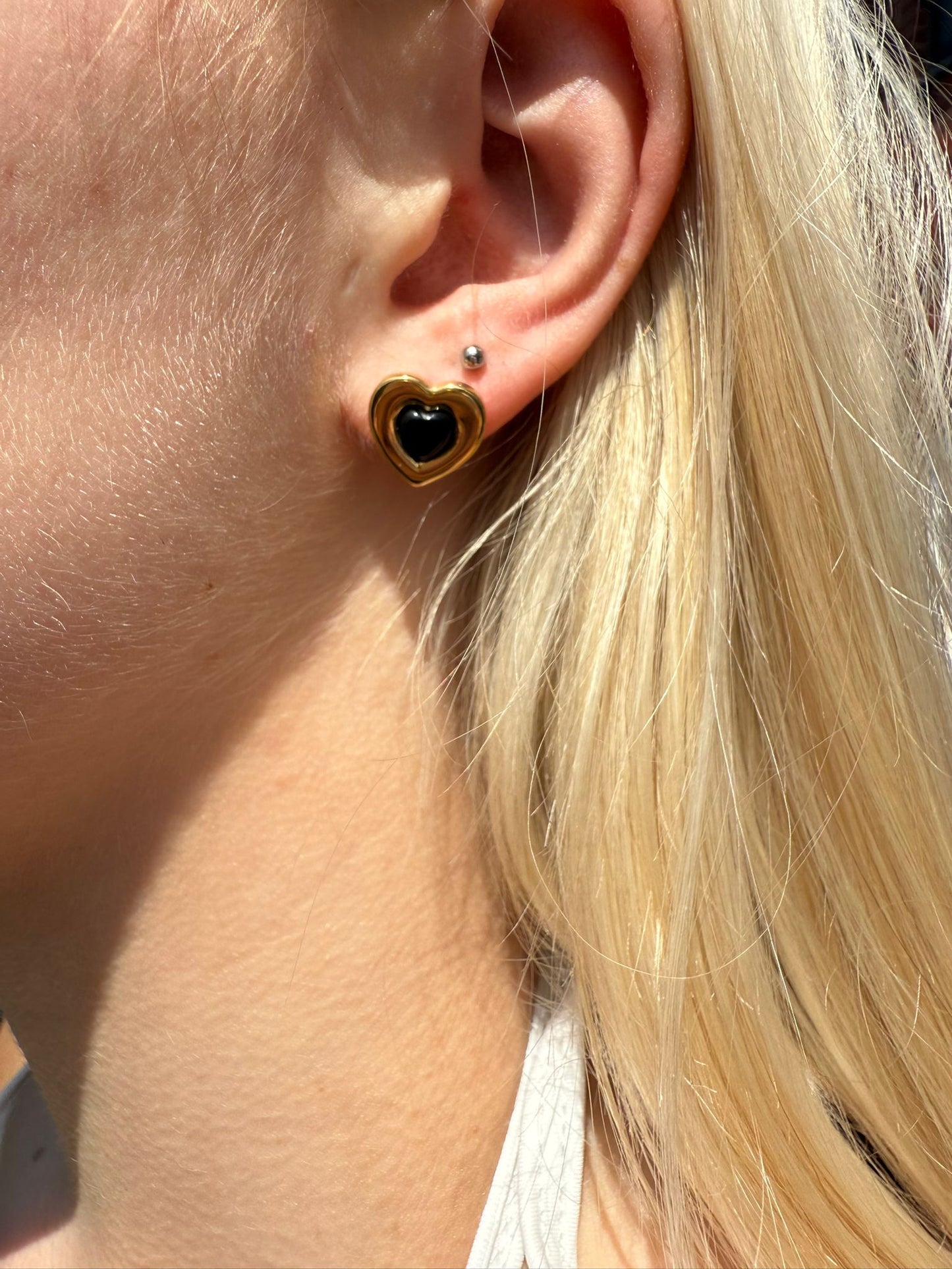 Gigi is a 18k AAA gold plated heart shape earrings with black hearts at the centre