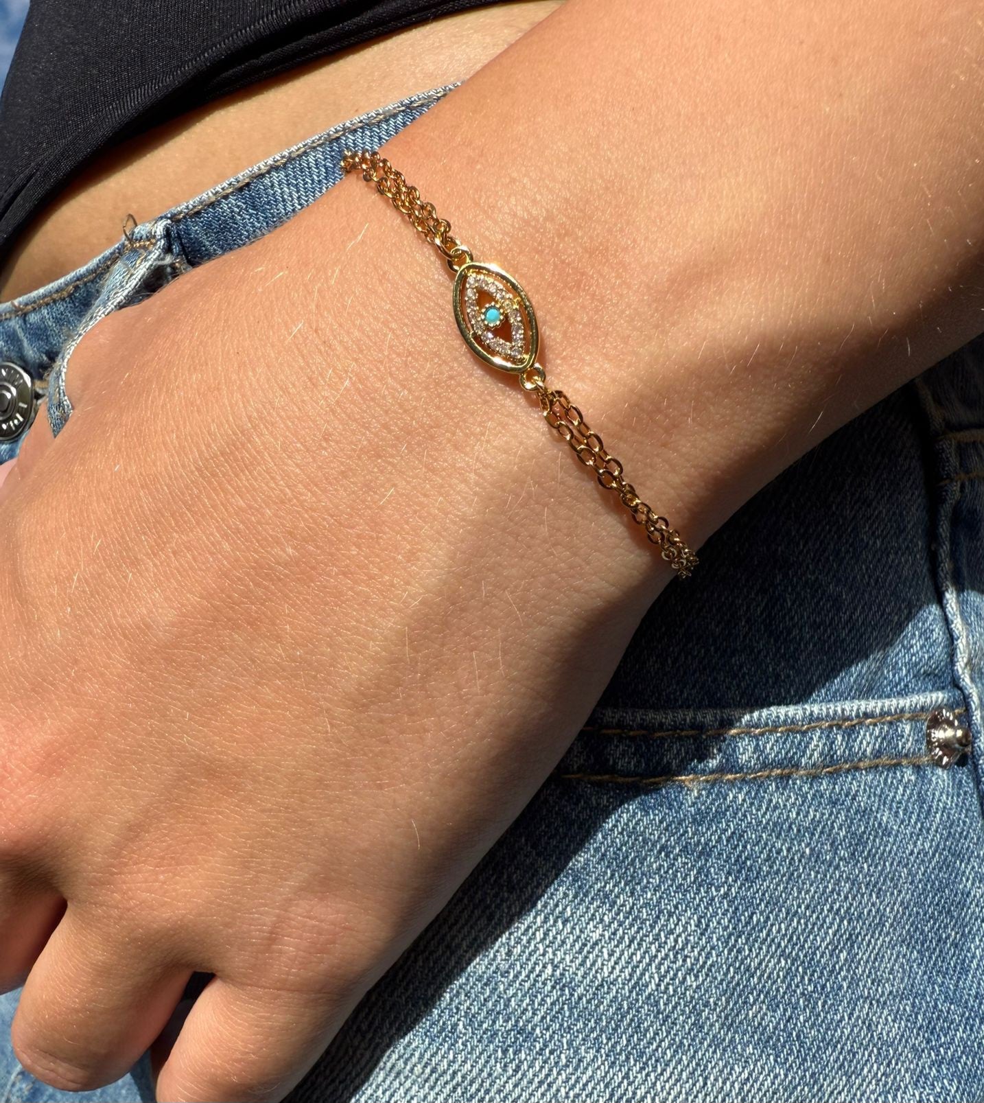 Edie is a 18K AAA gold plated two chain evil eye charm with zirconia diamond bracelet