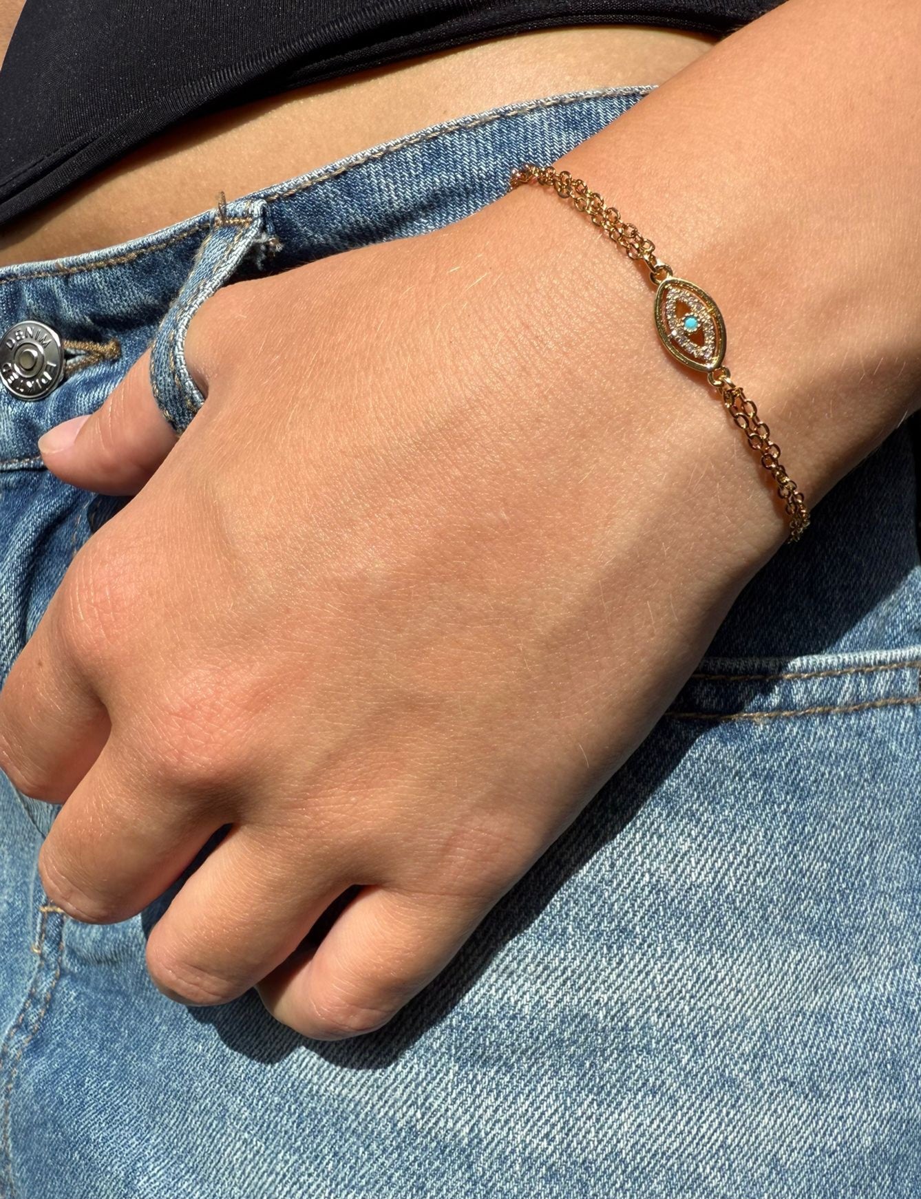 Edie is a 18K AAA gold plated two chain evil eye charm with zirconia diamond bracelet