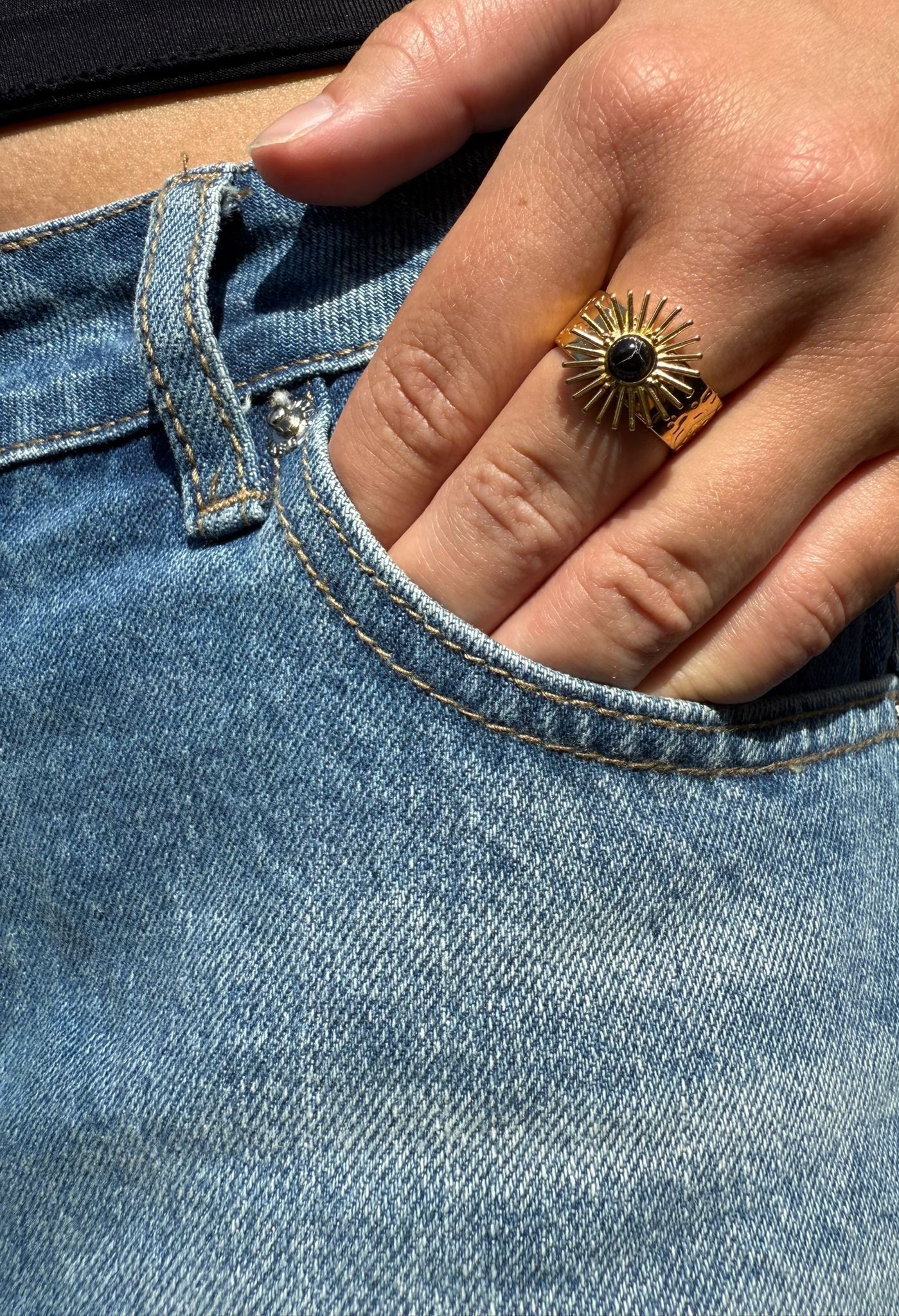 Greer is a 18k AAA gold plated adjustable ring with a sun dial with black stone