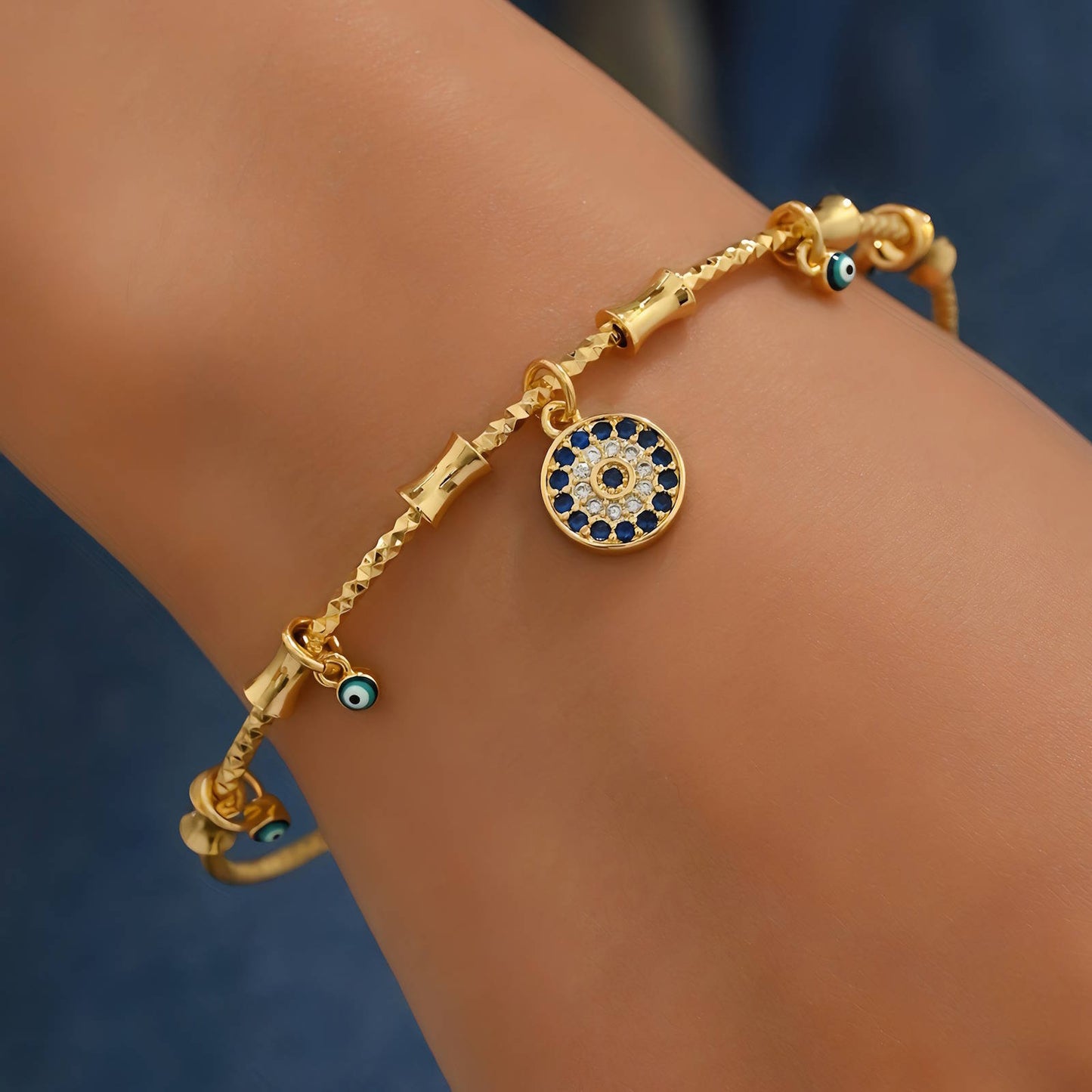 Imogen 18k AAA gold plated Evil eye bangle with lots of small charms