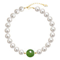 Indigo is a pearl bracelet with 18k AAA gold beads with a green bead at the centre