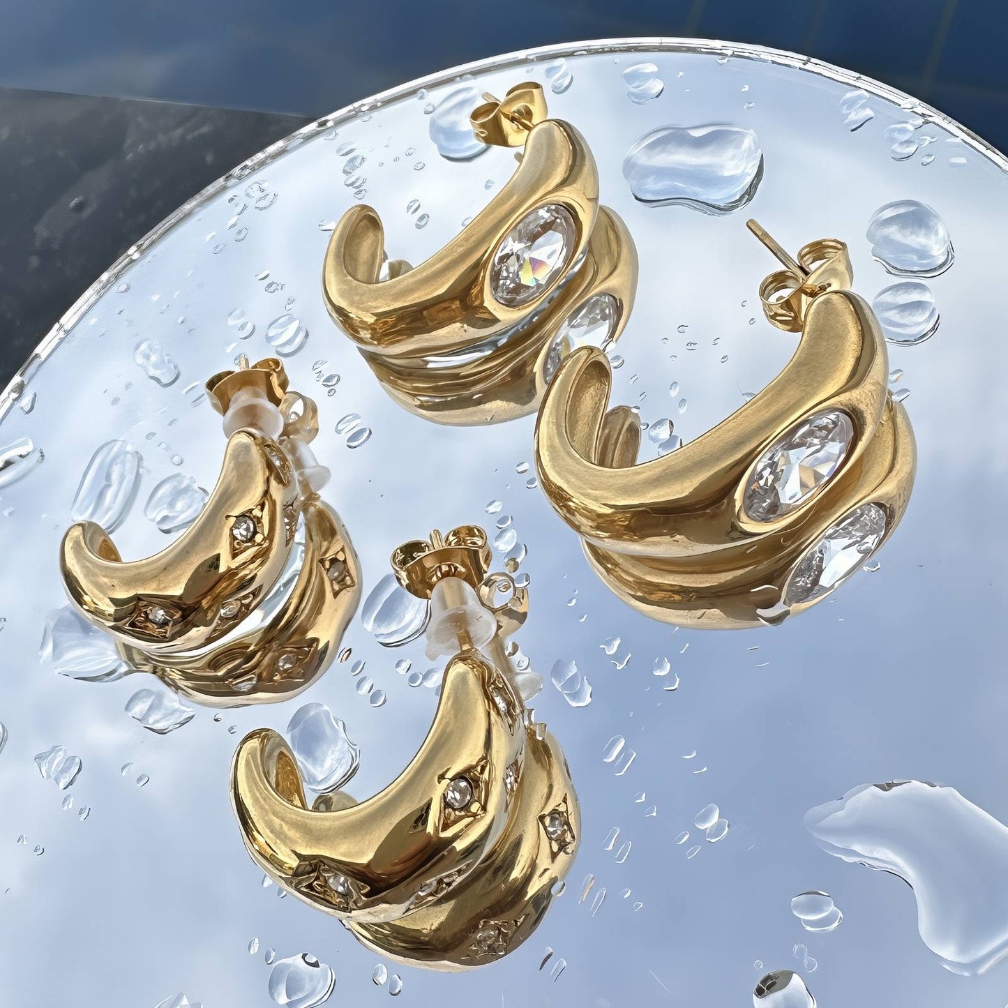 Oren is 18k AAA gold plated half hoop stud design earrings with a zirconia diamond