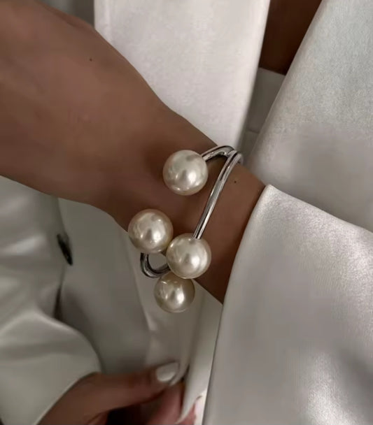 Poppy is a half silver bangle with four Pearls as a focal point
