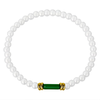 Anastacia is a pearl beaded bracelet with an 18k AAA gold plated beads and a green crystal