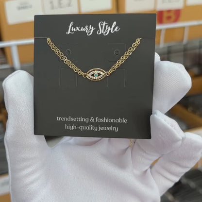 Edie is a 18K AAA gold plated two chain evil eye charm with zirconia diamond bracelet